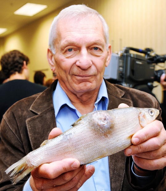 University of Alberta scientist David Schindler holding a deformed whitefish collected from the Athabasca watershed, downstream from the oilsands industrial development.